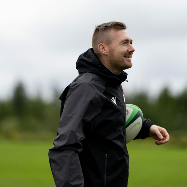 Jack Hanratty holding a rugby ball and smiling